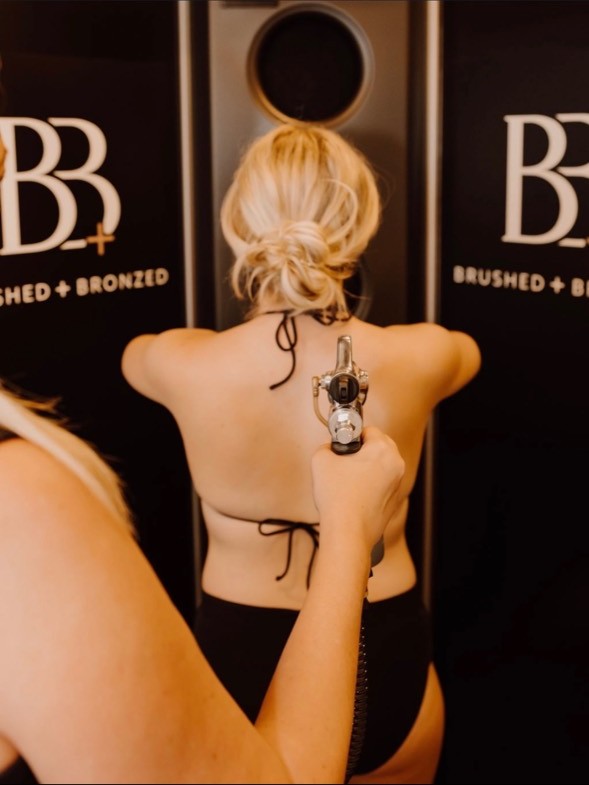 Custom spray tan application inside the Brushed + Bronzed studio